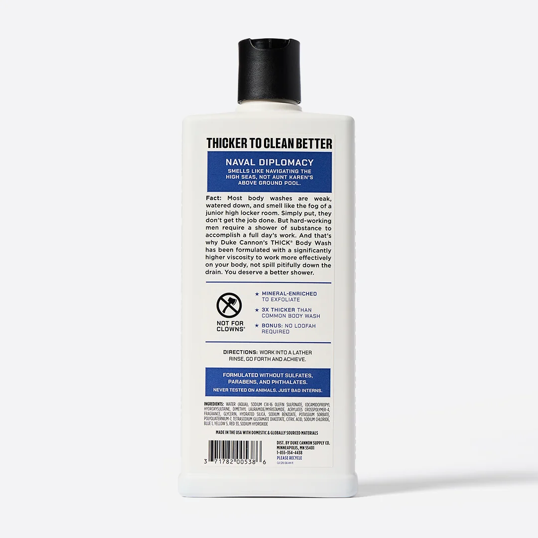 A tall, white, rectangular bottle of DUKE CANNON NAVAL DIPLOMACY THICK Body Wash with a black flip-top cap. Label with information in English: three times thicker than normal shower gel, a maritime fragrance with mandarin.