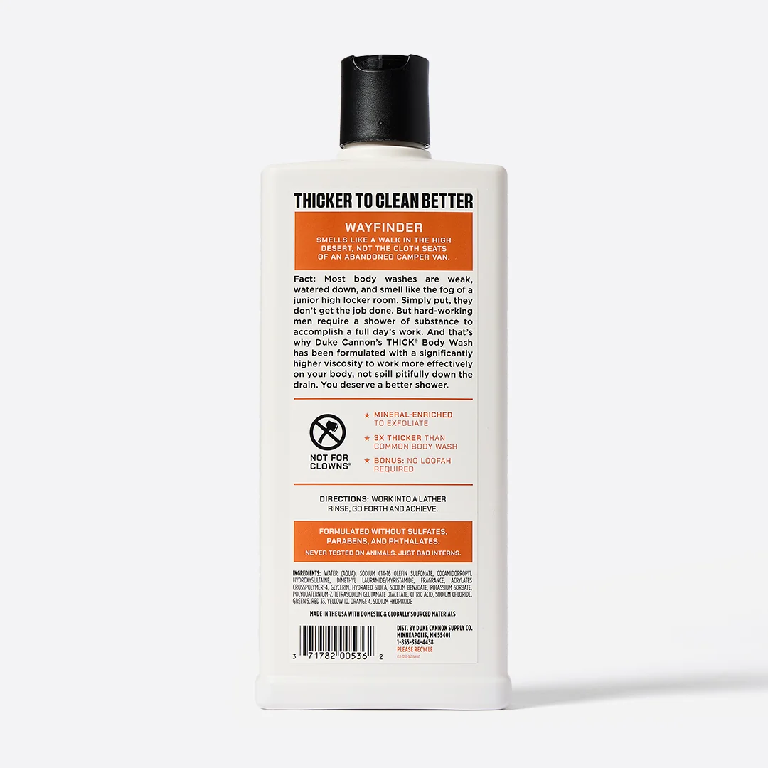 Upright, white, rectangular bottle of DUKE CANNON WAYFINDER THICK BODY WASH with a black flip-top cap. The label is clearly legible and displays the product name, description, ingredients and instructions for use in English. The background is light grey.